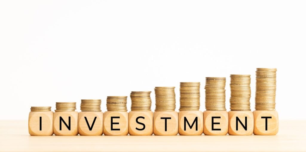 investment-concept-wooden-blocks-with-text-rising-stacked-coins-copy-space(1)