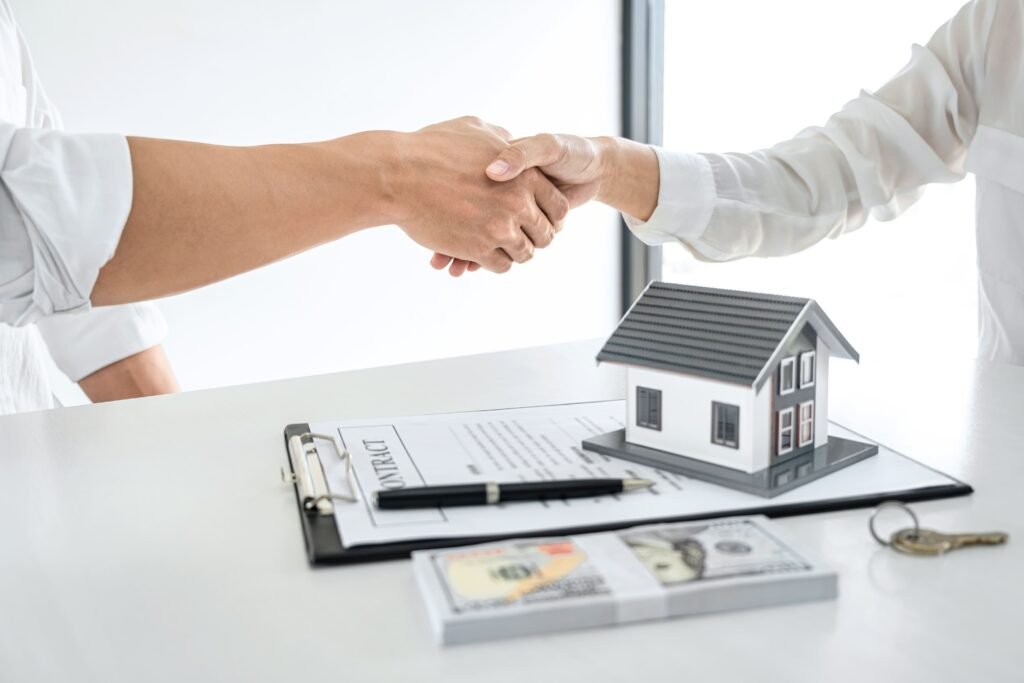 real-estate-agent-customers-shaking-hands-together-celebrating-finished-contract-after-signing-about-home-insurance-investment-loan-handshake-successful-deal(1)(1)